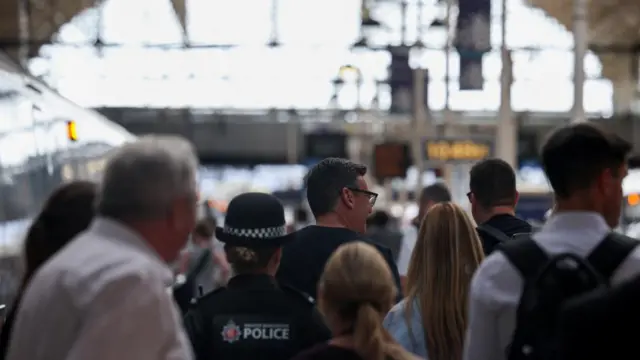 Andy Burnham walking along a train platform