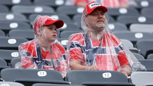 Norway fans in plastic rain ponchos in the stadium