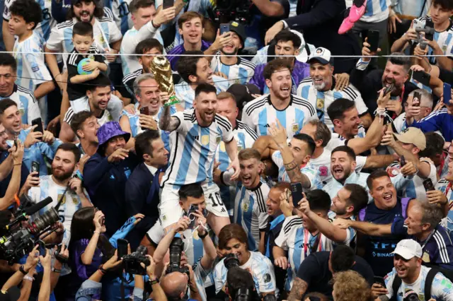 Messi with the World Cup trophy