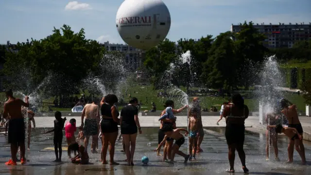 People play in a fountain at the Andre Citroen park as temperatures rise in Paris during a second heatwave affecting a large part of France, June 21.