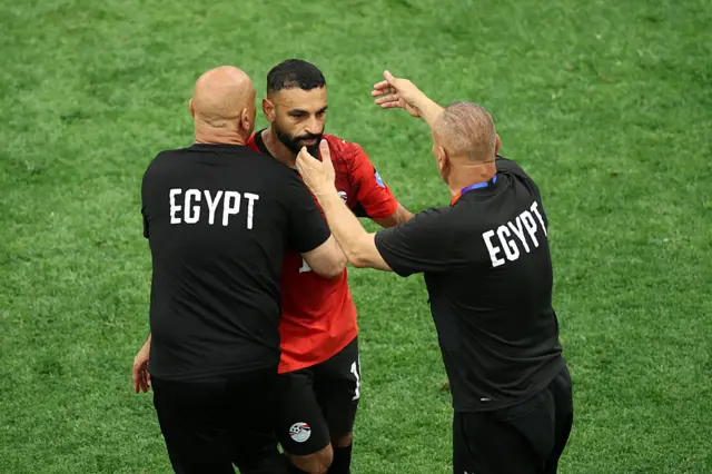 Mohamed Salah #10 of Egypt is embraced by Hossam Hassan, Head Coach of Egypt, as he is substituted during the FIFA World Cup 2026 Group G match between New Zealand and Egypt