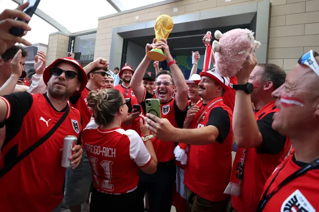 Austria fans lifting a World Cup replica
