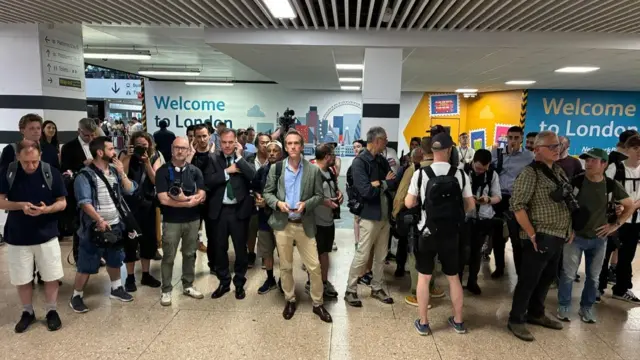 Pack of journalists waiting at Euston station for Andy Burnham to arrive on his train from Manchester