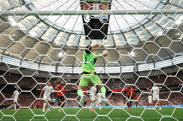 Mostafa Zico #11 of Egypt scores his team's first goal past Max Crocombe #1 of New Zealand during the FIFA World Cup 2026 Group G match between New Zealand and Egypt