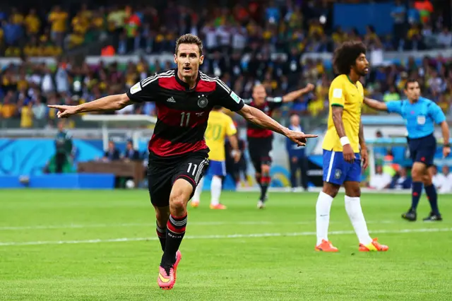 Miroslav Klose in a red and black Germany kit