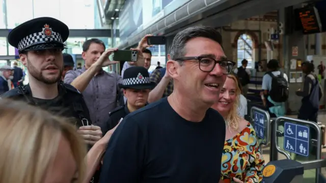 Newly elected Makerfield MP and former Greater Manchester Mayor Andy Burnham walks at Manchester Piccadilly station as he leaves for London