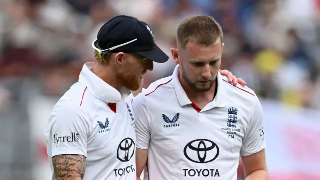 Ben Stokes with his arm around Gus Atkinson during a Test match