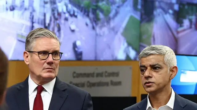 Britain's Prime Minister Keir Starmer, flanked by Mayor of London Sadiq Khan (R) stand in front of screens showing CCTV images of locations across London, as he meets with Metropolitan police officers to discuss operational planning ahead of this weekend's planned protests, in the Lambeth area of London on May 15, 2026