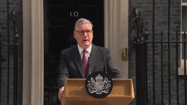 Keir Starmer standing outside Downing Street behind a lecturn