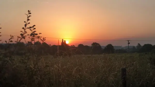 A warm orange sunrise above Somerton in Somerset.