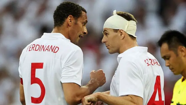Steven Gerrard and Rio Ferdinand speak to each other, whilst playing for England