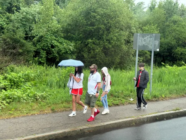 Fans arrive with brollies in Boston