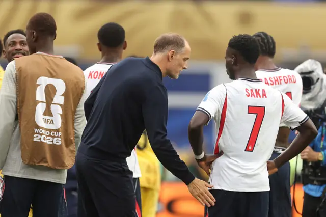 Thomas Tuchel, Manager of England, and Bukayo Saka #7 of England react