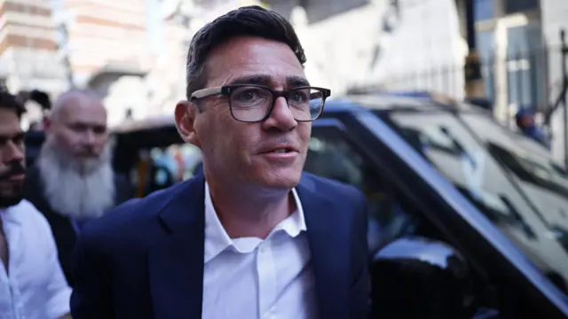 Andy Burnham arrives in Westminster with a black cab pictured behind him