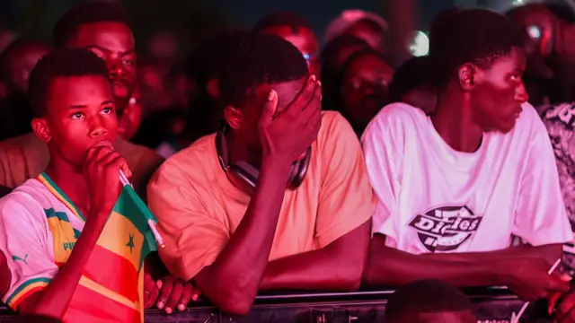 Senegalese football fans gather in front of a giant public broadcast screen at the Place de la Nation square in the capital city of Dakar, Senegal, on June 23, 2026, to watch the Senegal national team compete against Norway in the 2026 FIFA World Cup.
