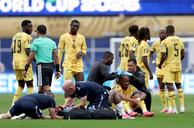Jordan Ayew #9 of Ghana receives medical attention