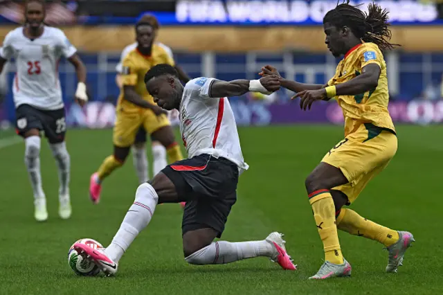 Marc Guehi (L) fights for the ball with Ghana's midfielder #03 Caleb Yirenkyi