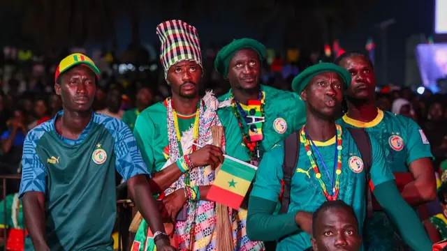 Senegalese football fans gather in front of a giant public broadcast screen at the Place de la Nation square in the capital city of Dakar, Senegal, on June 23, 2026, to watch the Senegal national team compete against Norway in the 2026 FIFA World Cup.
