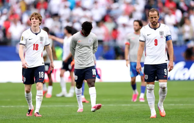 Anthony Gordon #18, Kobbie Mainoo #16 and Harry Kane #9 of England react