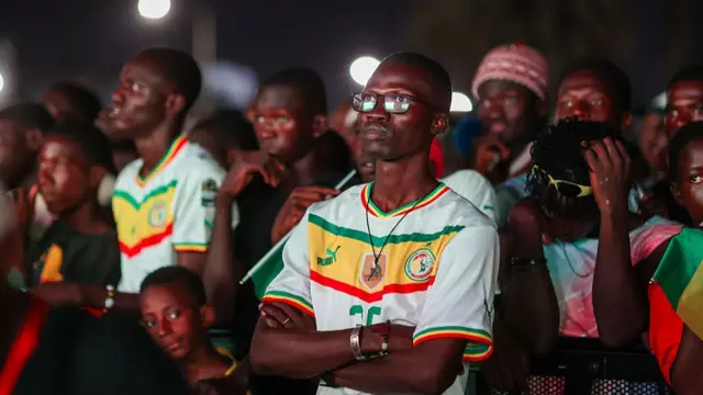 Senegalese football fans gather in front of a giant public broadcast screen at the Place de la Nation square in the capital city of Dakar, Senegal, on June 23, 2026, to watch the Senegal national team compete against Norway in the 2026 FIFA World Cup