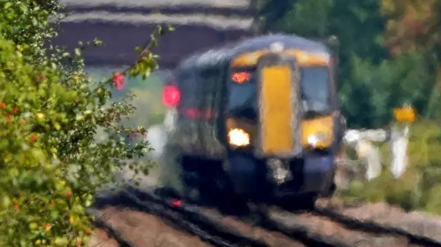 A train passes through heat haze on a railway line in Ashford, Kent - pictures on September 5, 2023