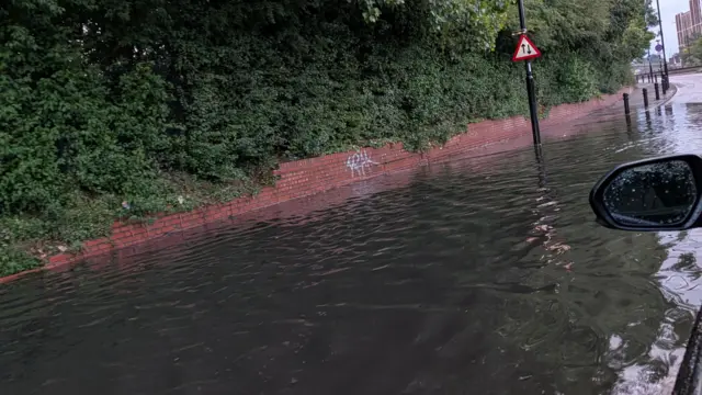Flooded street in west London after heavy rain