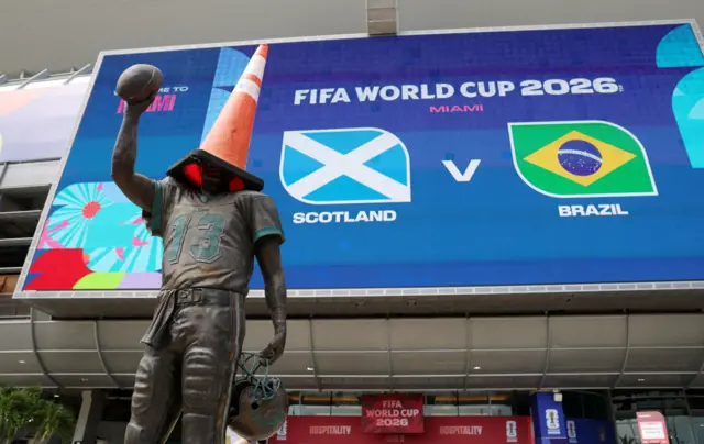 General view of a traffic cone on the statue of former Miami Dolphins quarterback Dan Marino as fans arrive outside the stadium before the match