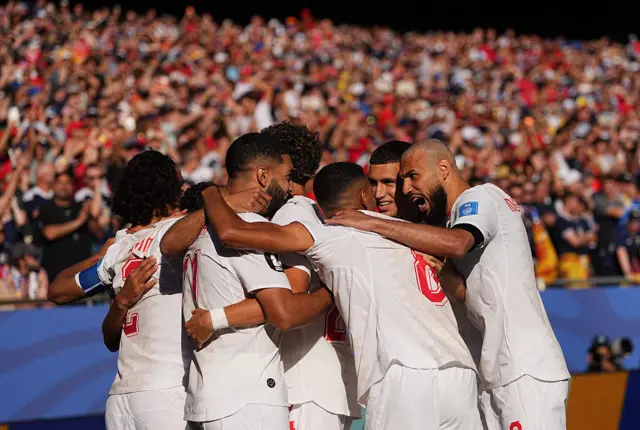 Morocco players celebrating a goal against Scotland