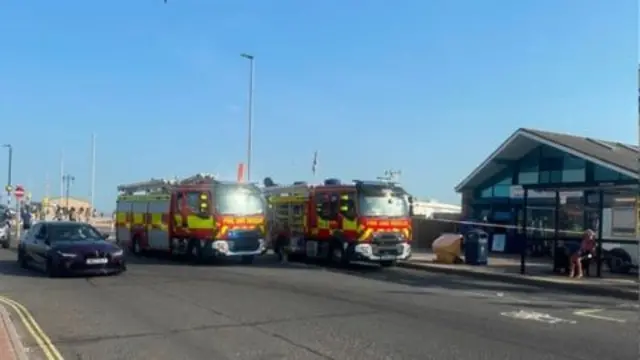 Two fire engines waiting outside a ticket station in Southsea