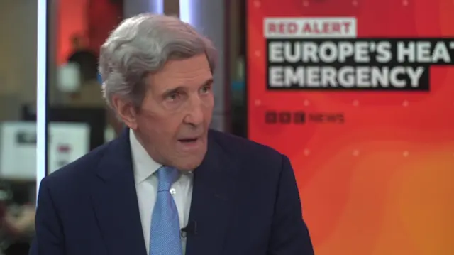 John Kerry in a suit and tie, speaking on the BBC.