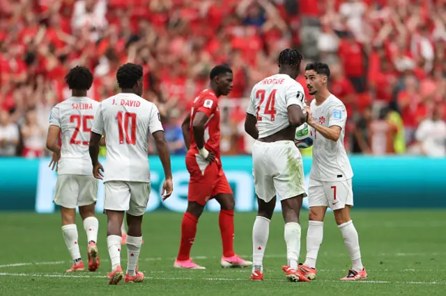Promise David #24 of Canada celebrates with teammates
