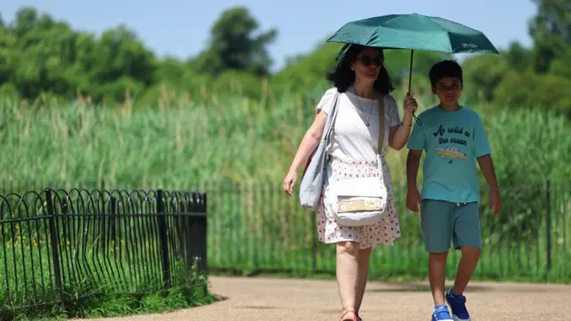 People walking in Hyde Park in the sun