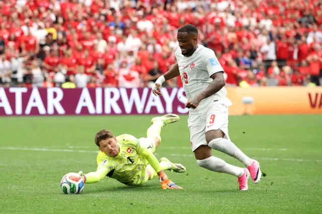 Gregor Kobel #1 of Switzerland blocks Cyle Larin
