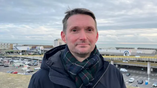 Chris Ward, a man in a scarf and jacket, in a photo taken in January 2025.