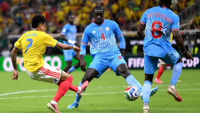 Luis Diaz of Colombia shoots and misses a chance against Axel Tuanzebe #4 and Samuel Moutoussamy #8 of Congo DR during the FIFA World Cup 2026 Group K match.