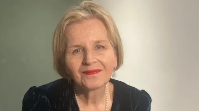 Donna Ockenden, with short blonde hair, looks straight ahead at the camera