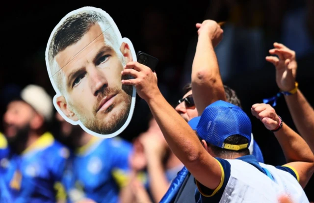 A Bosnia and Herzegovina fan displays a Edin Dzeko banner