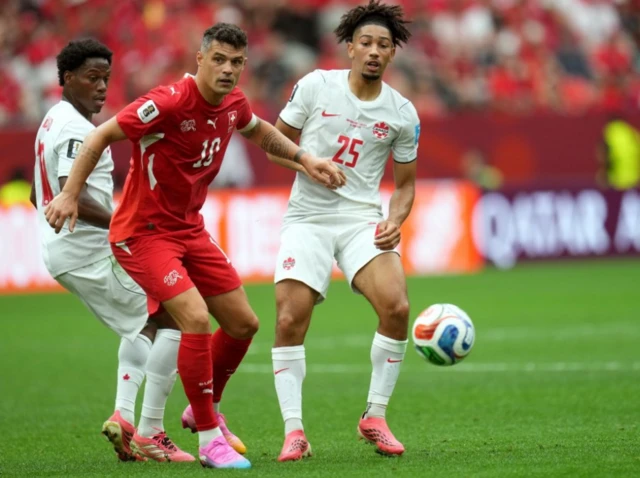Nathan Saliba of Canada (R) and Granit Xhaka of Switzerland in action