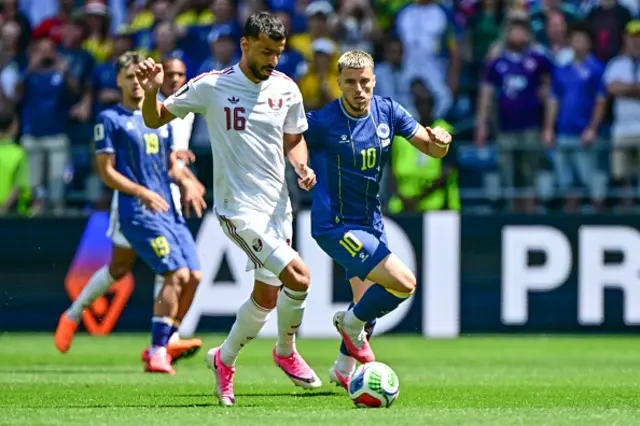 Qatari Assim Madibo and Bosnia and Herzegovina's Nihad Mujakic fight for the ball