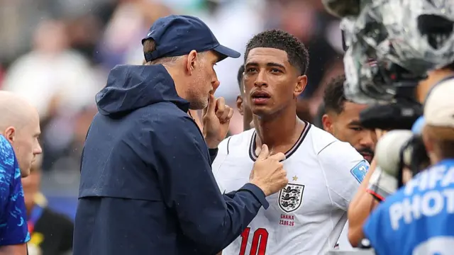 Thomas Tuchel, Manager of England, speaks to Jude Bellingham #10 of England at the hydration break during the FIFA World Cup 2026 Group L match between England and Ghana at Boston Stadium on June 23, 2026 in Foxborough, Massachusetts.
