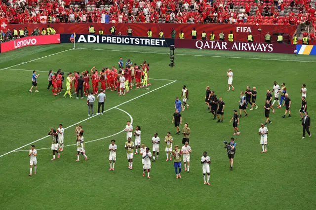 Players of Switzerland applaud fans