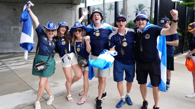 cheering men and women in Scotland strips outside the stadim