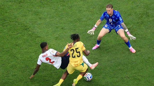 Ezri Konsa of England puts in a last ditch tackle on Prince Kwabena Adu of Ghana as England goalkeeper Jordan Pickford is ready to close them down during the FIFA World Cup 2026 Group L match between England and Ghana at Boston Stadium on June 23, 2026 in Foxborough, United States.