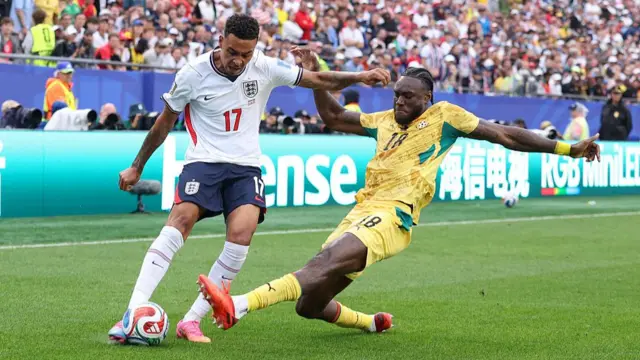 Morgan Rogers crosses the ball under pressure from Jerome Opoku