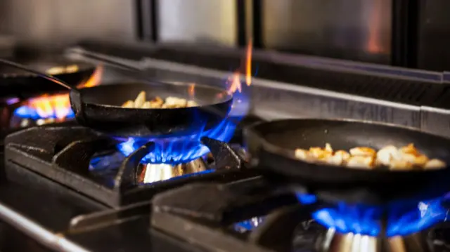 Pans on gas rings in kitchen