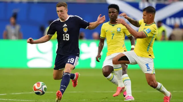Lewis Ferguson and Lucas Paqueta in action
