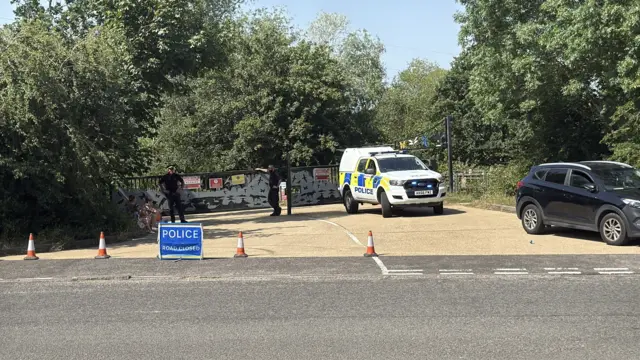Police at closed entrance to lakes