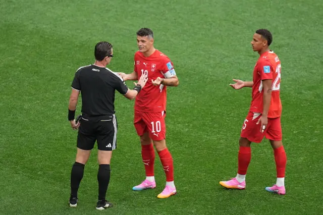 Referee Ramon Abatti talks to Granit Xhaka of Switzerland