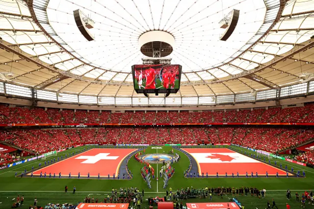 Players and match officials walk into the pitch