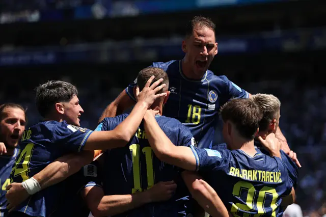 osnia and Herzegovina players celebrate after an own goal by Sultan Albrake #18 of Qatar